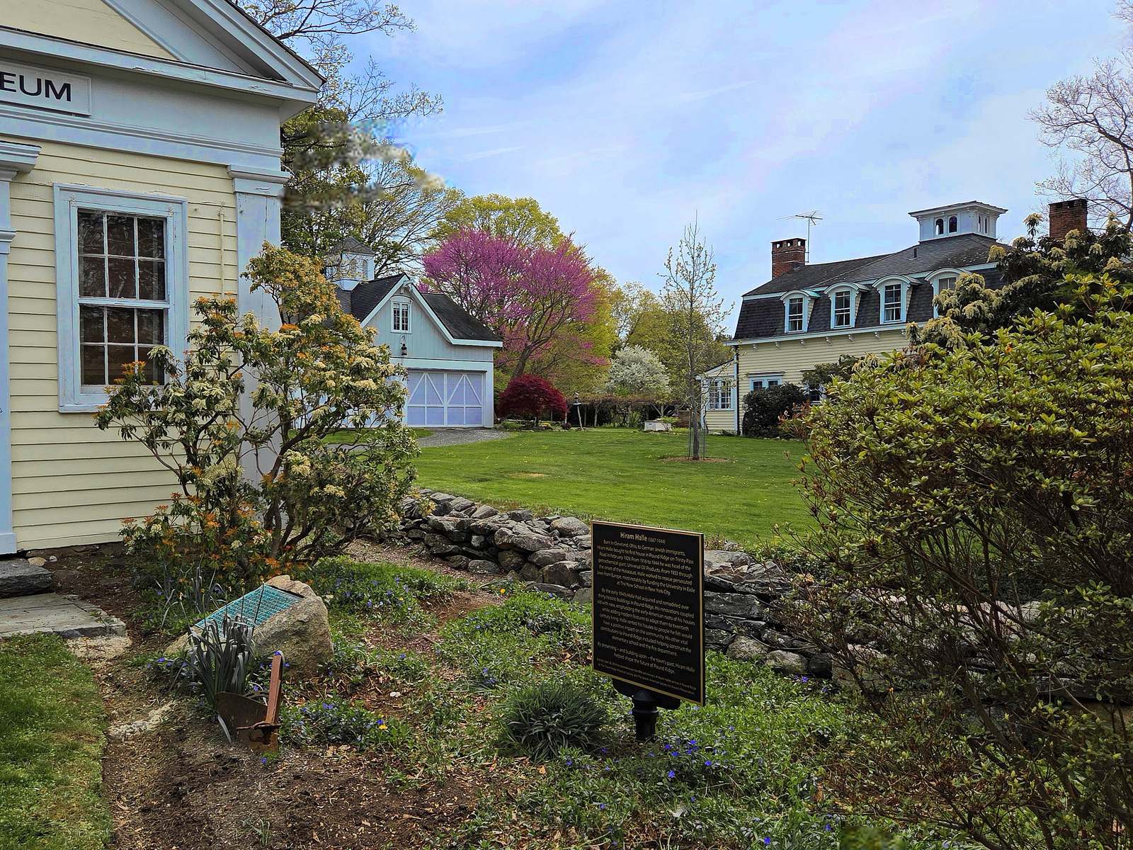 Pound Ridge Historic District, Pound Ridge, NY: clapboard museum building, carriage barn, and a mansard-roof house behind a fieldstone wall, with no people, for a Pound Ridge appraisal guide