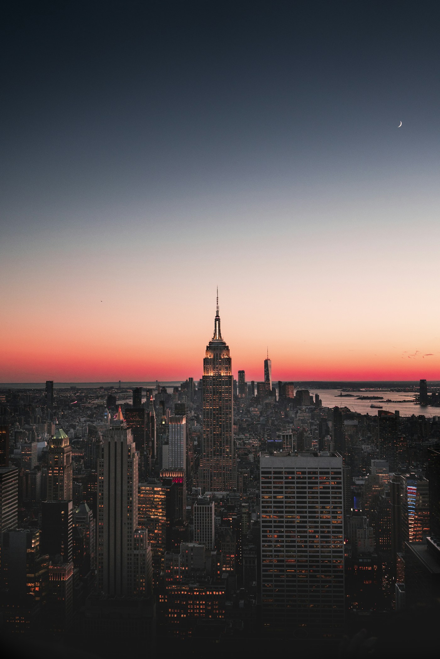 Manhattan skyline at dusk with city lights and the Empire State Building